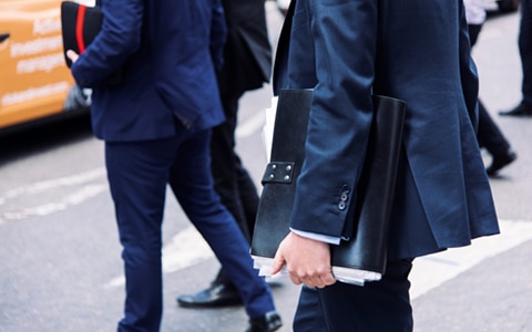 men wearing suits carrying files