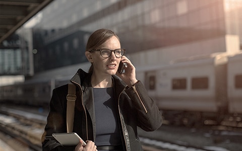 woman talking on phone to take steps to safeguard business from terrorism risk